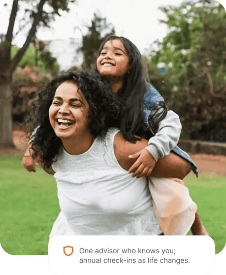 A mother laughing in a park while her daughter hugs her from behind, with a card reading: One advisor who knows you; annual check-ins as life changes.